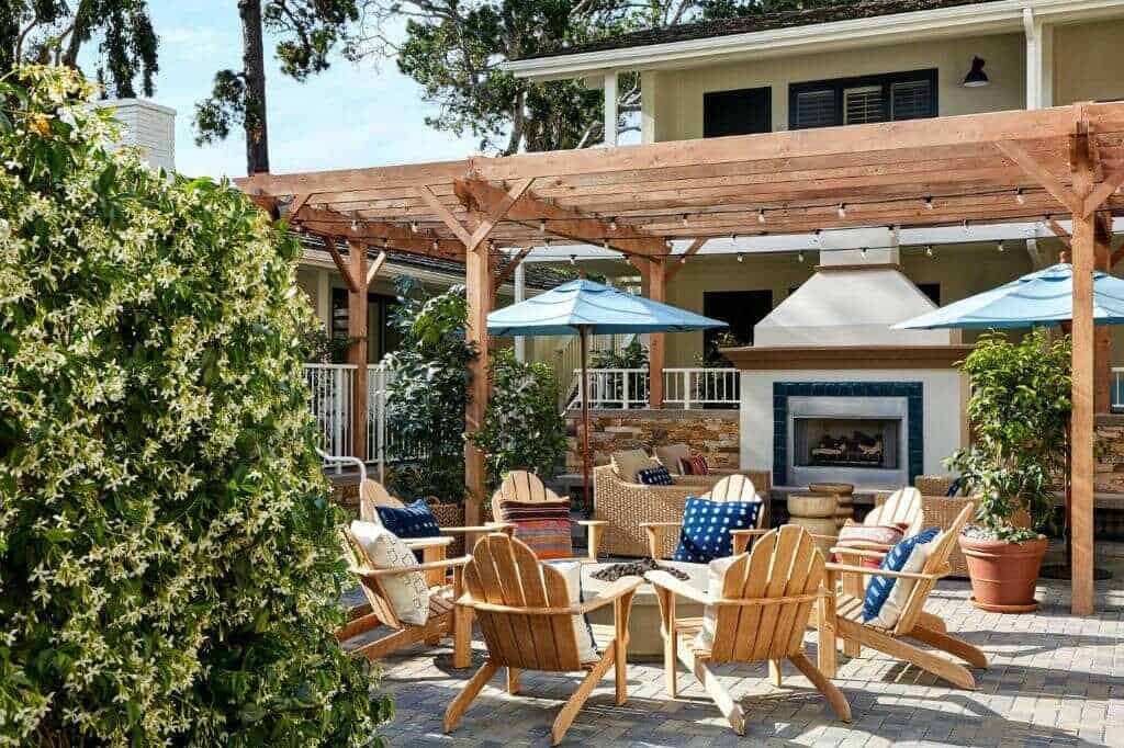 Relaxing outdoor patio with Adirondack chairs, firepit, and pergola in California.