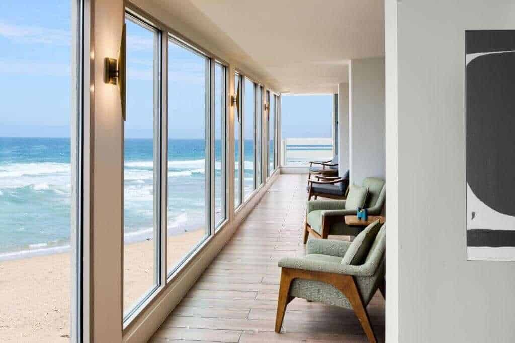 Stunning California beach hotel room with ocean views, comfortable seating, and modern design. Ideal for coastal getaways.