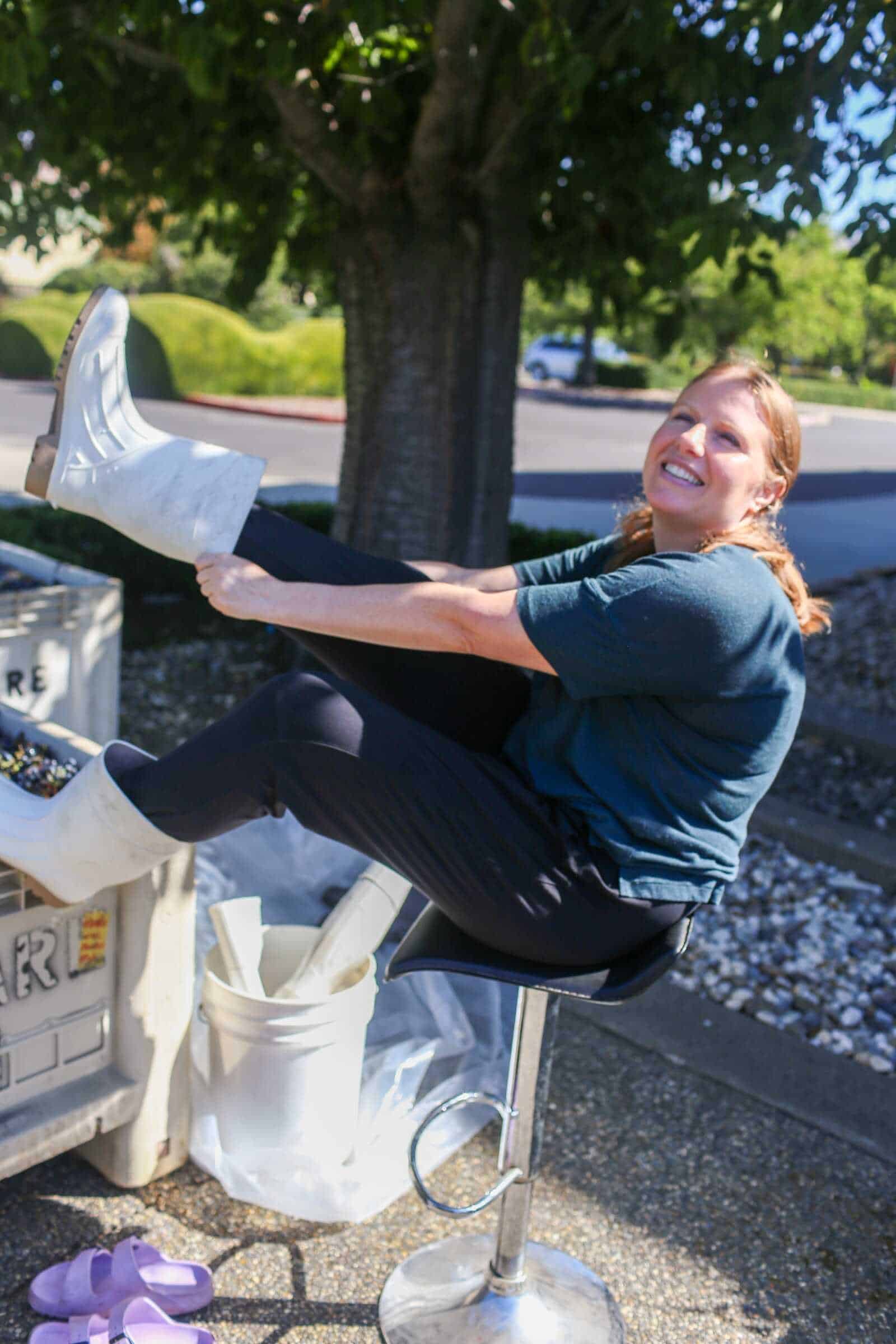 Happy woman stretching outdoors in California, enjoying the sunny day and nature.