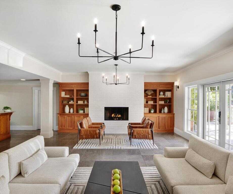 Modern living room with fireplace and stylish decor, perfect for California home design enthusiasts.