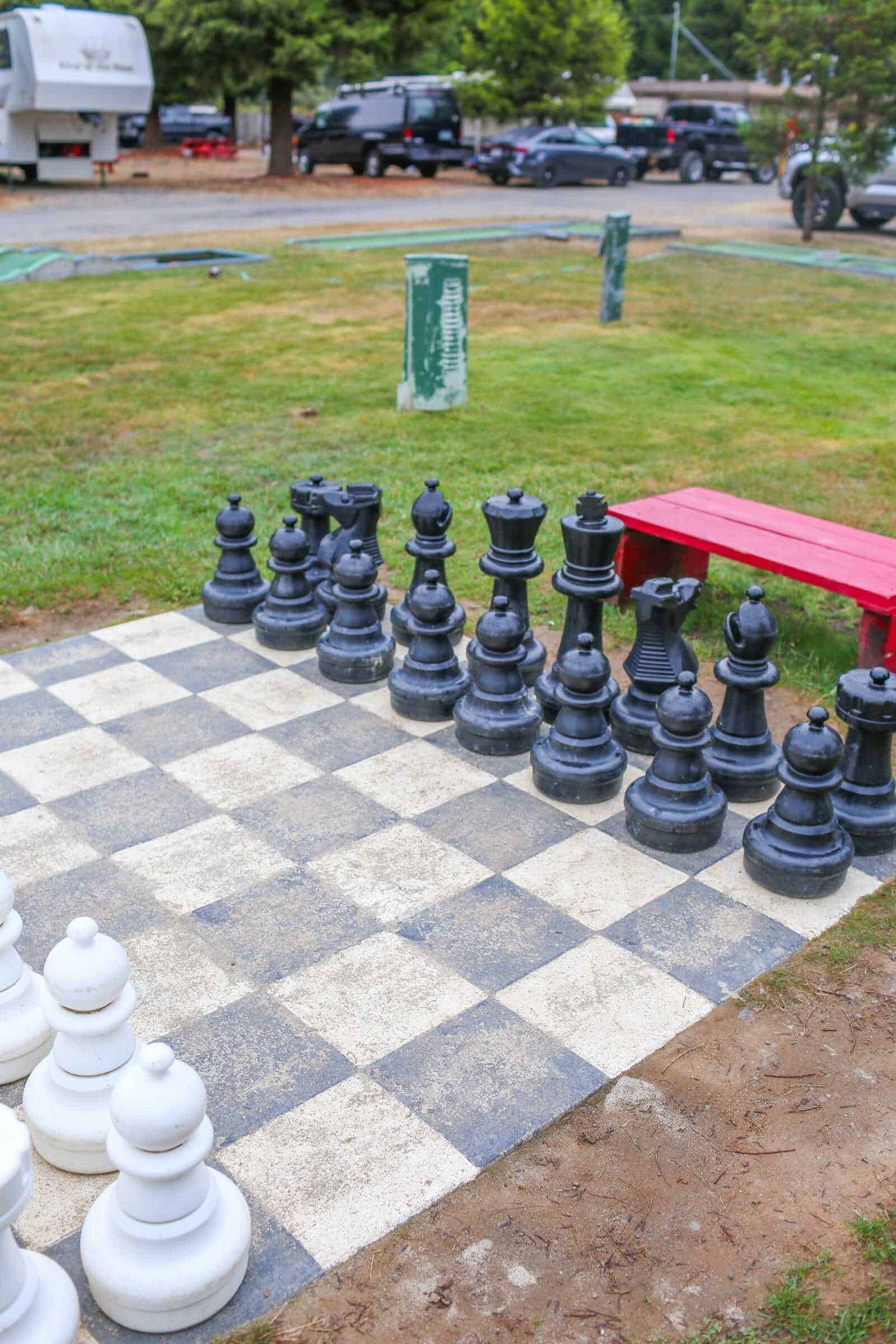 Chess set on outdoor board in California campground.