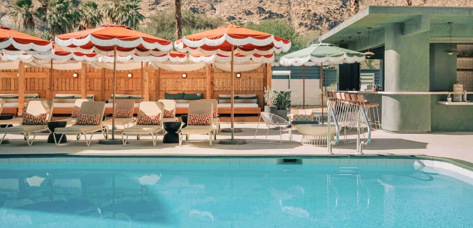 Poolside lounge area at Palm Springs California in with umbrellas and modern décor.